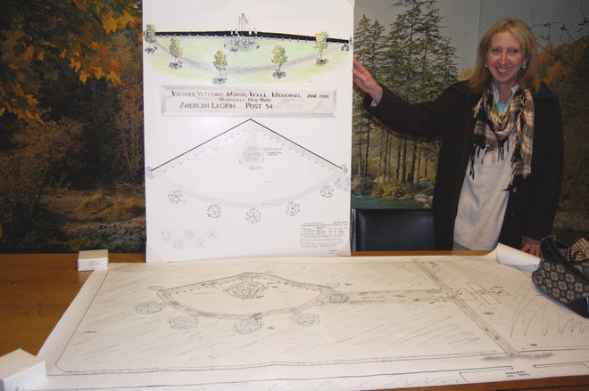 Susan Storms-McNeal, American Legion Head of Landscaping for the Moving Wall event, is shown with the blue-prints and artist’s conception drawing of the event’s site. The baseball/soccer field of the Stockbridge Valley Central School will be transformed into a tranquil setting, paying tribute to those who lost their lives in the Vietnam conflict.