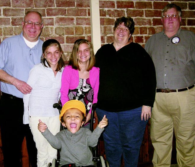 Galva Lions Club member Gary Coon (right) stands with Steve and Jean Grys and their children, twins Abby and Bekah, 17, and Jake, 8, after the family shared their experiences of being on the “Extreme Makeover: Home Edition” TV show. The family, of Pekin, appeared at the Feb. 25 Lions meeting, invited by Coon. Jake is proudly displaying a Lions cap given to him during the evening.
