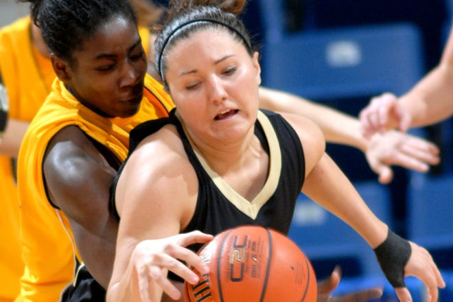 UNC Greensboro's TaShama Bammer, left, tries to steal the ball from Wofford's Maddie Helms on Thursday.