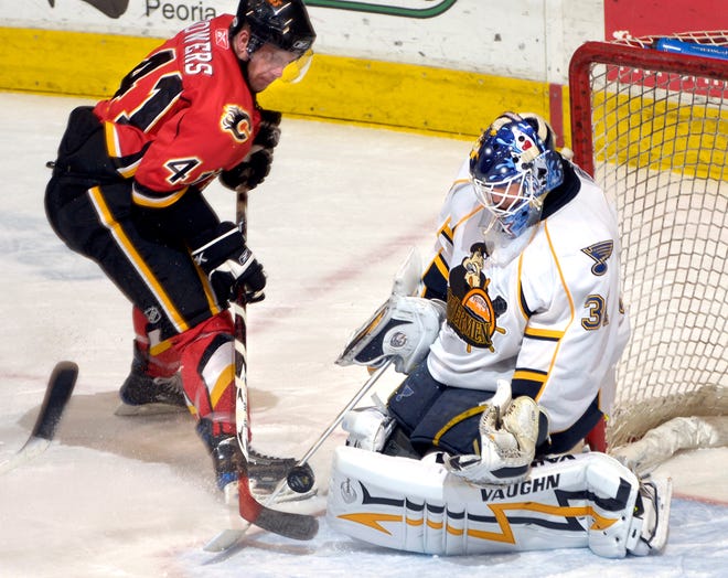 Rivermen goaltender Chris Holt goes toe-to-toe with Justin Bowers of the Quad City Flames on a save late in the third peoriod Wednesday night at Carver Arena. The Rivermen won 5-2.