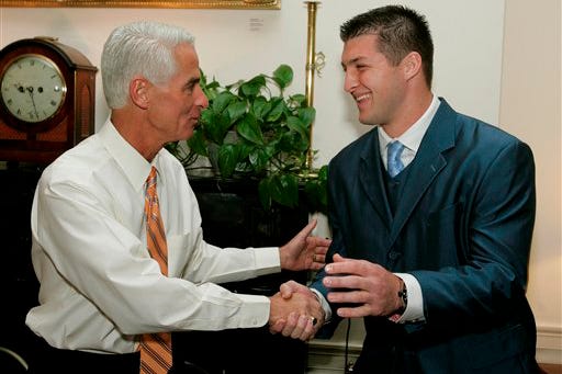 Gov. Charlie Crist, left, shakes hands with University of Florida quarterback Tim Tebow during Tebow's visit to the Governor's Mansion, Thursday, March 5, 2009, in Tallahassee, Fla.