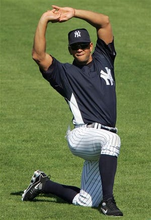 In this Feb. 18, 2009 file photo, New York Yankees' Alex Rodriguez stretches during spring training baseball in Tampa, Fla. The Yankees star will miss up to two months after he undergoes surgery to remove a cyst from his right hip.