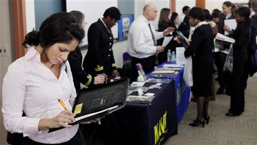 Sanah Hamad looks over her list of employers to visit during a job fair at Roosevelt University in Chicago, Thursday, March 5, 2009. The government says the nation's unemployment rate bolted to 8.1 percent in February, the highest since late 1983, as cost-cutting employers slashed 651,000 jobs. (AP Photo/Charles Rex Arbogast)