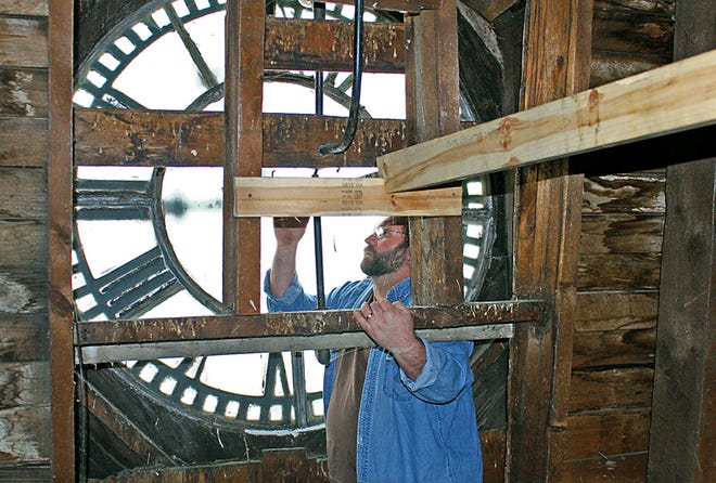 Mark Ferraro, Chippewa County Courthouse maintenance employee, checks out the clock at the top of the building as he prepares to change the time in order to “Spring Ahead” to Daylight Savings Time at 2 a.m. Sunday. According to Jim German, County Administrator, the clock — which is as old as the building, built in 1877 — just had repairs made to it late last summer.