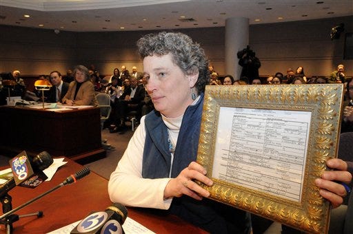 Connecticut state Rep. Beth Bye holds her marriage license, the first one issued to a gay couple in Conn., as she adresses the General Assembly's Judiciary Committee at a hearing on Senate Bill 899 held in the Legislative Office Building at the state Capitol in Hartford, Conn., on March 6, 2009. The bill, "implements the guarantees of equal protection under the Connecticut Constitution for same-sex marriages."