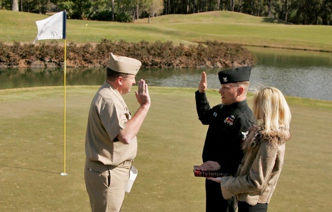 SPECIALPetty Officer 2nd Class Jason Zirk (center), a sonar tech aboard the submarine USS Georgia, chose the 17th hole at the TPC Sawgrass Stadium Course to sign up for another tour of duty.