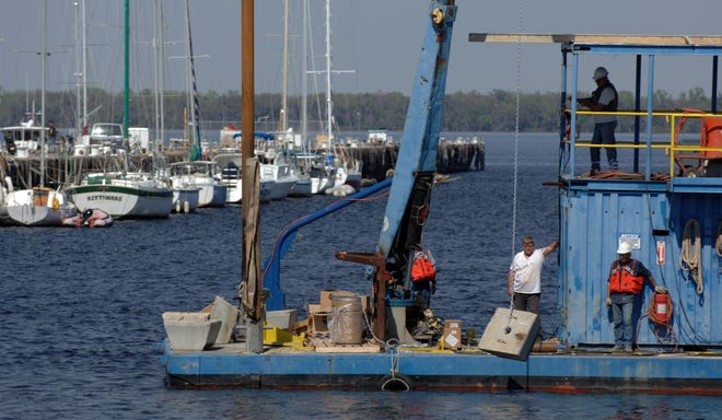 BOB SELF/The Times-UnionCrews sink boat-mooring anchors in the waters between the two piers that have been declared unsafe at the Green Cove Springs Marina. Boaters - some of whom live on their craft and are on a fixed income - have been told they must leave. "It's a real jolt to them," one official said.