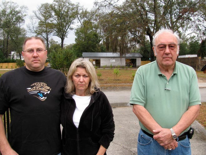 MARY MARAGHY/My Clay SunTom Berrier, his wife Joyce and neighbor Warren Niemi stand on the Berrier's driveway. They are angry about the weekend traffic created by Waste Not Want Not, a food distribution center across the street from the Berrier's home.
