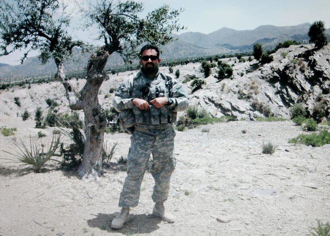 In this undated image provided by the Bhatia family Michael Bhatia poses in rural Afghanistan. Bhatia, an academic, was killed in Afghanistan in May of 2008 while working for the Human Terrain System program. This image was in a camera that was returned to the Bhatia family, of Medway, Mass., by the U.S. Military along with other personal effects following his death. (AP Photo/Bhatia Family Photo)