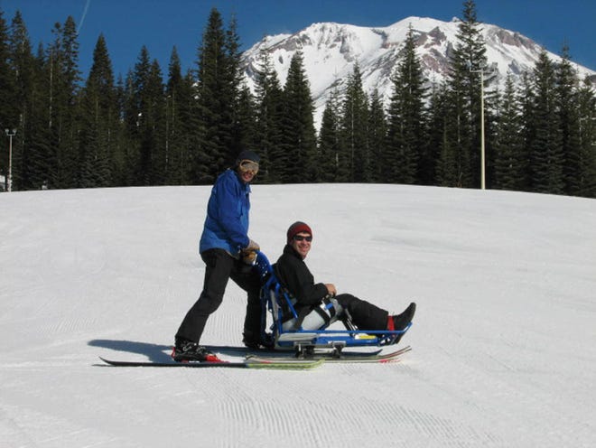 DSUSA member Conrado goes skiing with volunteer Aaron Beverly at last year's adaptive Weekend.