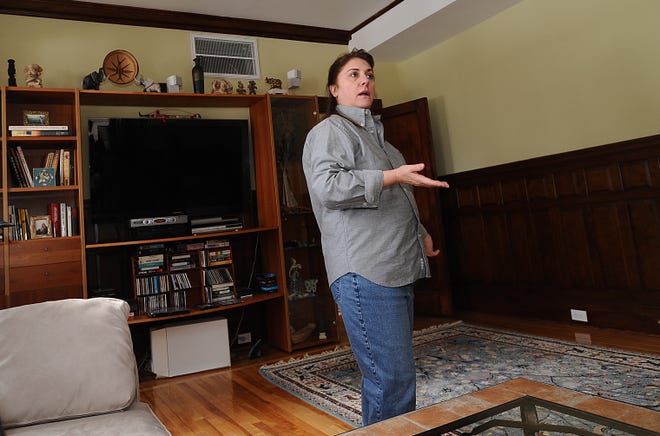 Pamela Clowes, the first resident to move in at St. Mary's Condominiums in Marlborough, talks about her new home while standing in her living room during Tuesday's open house.
