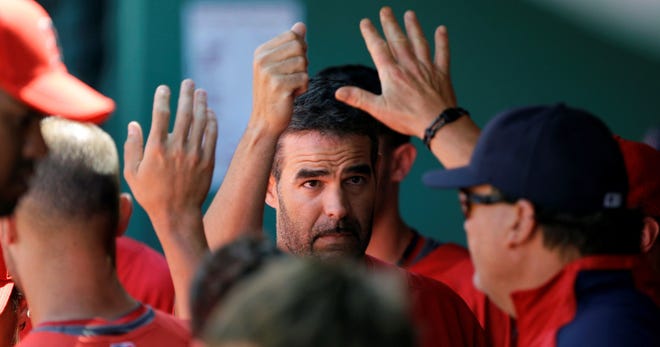 Mike Lowell is congratulated by teammates after his single in the seventh inning of the the Red Sox' 5-1 loss to the Orioles on Tuesday in an exhibition game in Fort Myers, Fla.