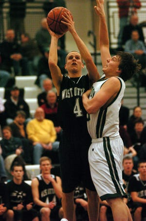 Dennis R.J. Geppert/The Holland Sentinel 
West Ottawa's Colton Overway (4) puts up a shot while Jenison's kyle Hoek (33) tries to guard him Wednesday night at West Ottawa High School.