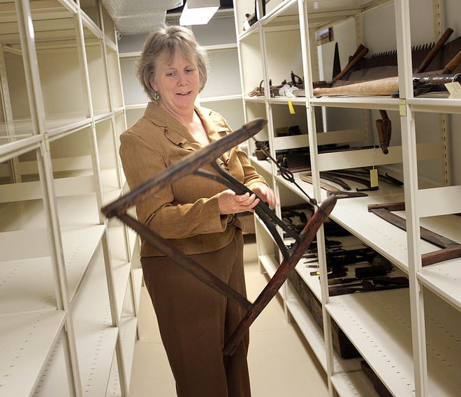 Marshfield Historical Society President Dorothy MacMullen holds one of the items, a saw, being kept at the Marcia Thomas House museum on Webster Street.



GREG DERR