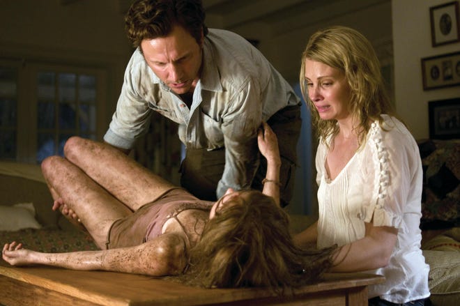 In this film still released by Rogue Pictures, Sara Paxton, Tony Goldwyn and Monica Potter, right, are shown in a scene from "The Last House on the Left."