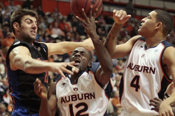 Florida's Dan Werner (21) blocks the shot of Auburn's DeWayne Reed (12) as Lucas Hargrove (4) tries to avoid the collision during the teams' first game in Auburn, Ala., Wednesday, Jan. 14, 2009. Florida won 68-65.