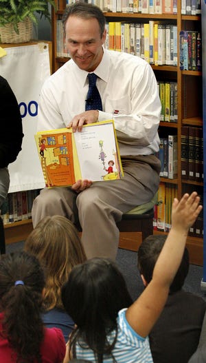 The past two Kansas attorneys general were embroiled in controversy. Stephen Six, the current officeholder, wants to change the public's perception of the office. Here he takes a break to read at Whitson Elementary.