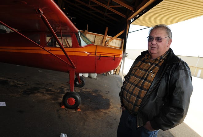 Jack Hooker stands next to his Cessna 120 in his hangar at Albertus Airport in Freeport Thursday, March 12, 2009. Hooker is one of many tenants that is dealing with a recent rate increase by the city of Freeport.