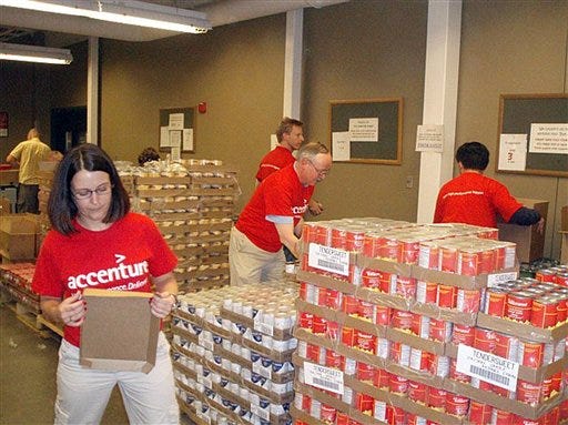 Volunteers stack goods at the Second Harvest Heartland Distribution Center in Minn. Nonprofit groups around the country are reporting record-setting volunteer interest. A combination of high unemployment, President Obama's call to community service, and a general sense of wanting to help others through tough economic times seem to be turning this recession into a volunteer boom time.