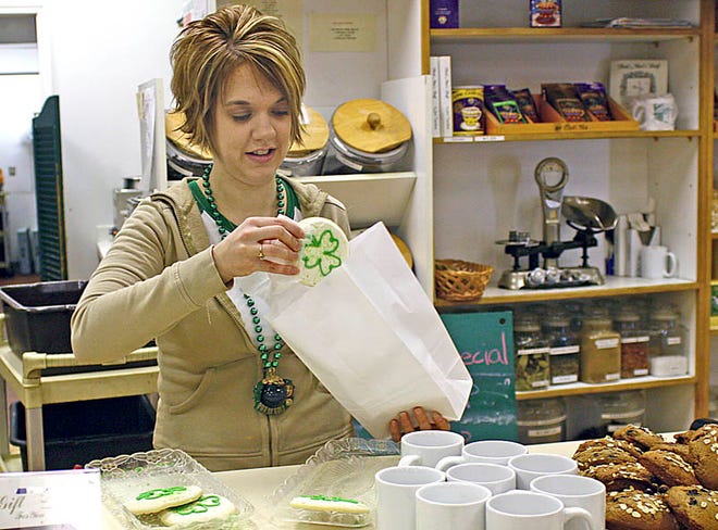 Dusty LaLonde, of the Sault, bags up some tasty shamrock cookies at Penny’s Kitchen early Tuesday morning. The eatery specially designed the baked treats to celebrate St. Patrick’s Day.