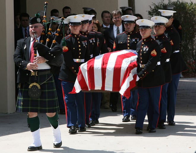 Members of the U.S. Marine Corps carry the casket of Lance Cpl. Patrick A. Malone out of Blessed Trinity Catholic Church on Tuesday.