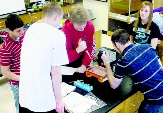 THE AP BIOLOGY STUDENTS AT LITTLE FALLS HIGH SCHOOL used equipment and materials provided by the Cornell Institute for Biology Teachers to conduct their high-tech DNA analysis laboratory on Saturday. Unlike years past, when the students traveled to Cornell University, the equipment was shipped to the high school for use by the students.