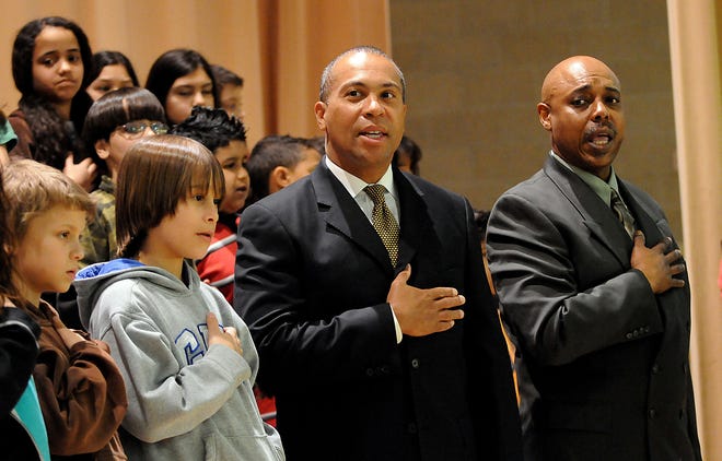 Gov. Deval Patrick and Robin Welch, right, principal of the Woodrow Wilson School in Framingham and Woodrow Wilson Students sing the national anthem during Patrick's appearance at the school to announce that Federal stimulus money will be used for education Thursday.