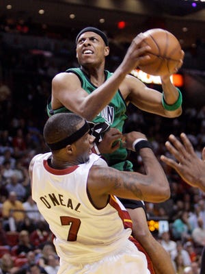 Boston Celtics' Paul Pierce, top, fouls Miami Heat's Jermaine O'Neal (7) while heading to the basket in the second quarter of an NBA basketball game in Miami, Wednesday, March 11, 2009. (AP Photo/Alan Diaz)