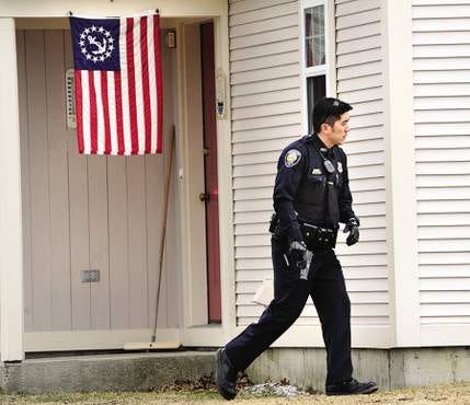 Portsmouth police officer John Lee searches the area of Osprey Landing on Wednesday afternoon, March 18, following a report of a possible gun threat.