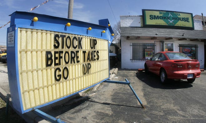 The billboard at the North Topeka Smoke House, 1834 N.W. Topeka Blvd., advises smokers to stock up before taxes increase.