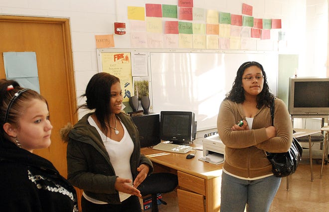 Students (from left) Ashley Balsiger, Markita Fane and Kayla Reed give a tour of the Banks/Bergagna Education Center in Freeport during an open house for the new facility Thursday.