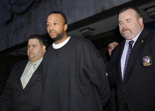 New York City Police Detectives escort Keith Phoenix, center, from the 83rd Precinct in New York after his arrest for murder as a hate crime, Friday, Feb. 27, 2009, in New York. Phoenix is the second man charged in the December 2008 death of an Ecuadorean man who had been walking arm-in-arm with his brother before being hit with a baseball bat and kicked by men shouting anti-Hispanic and anti-gay slurs. (AP Photo/Newsday, Charles Eckert)