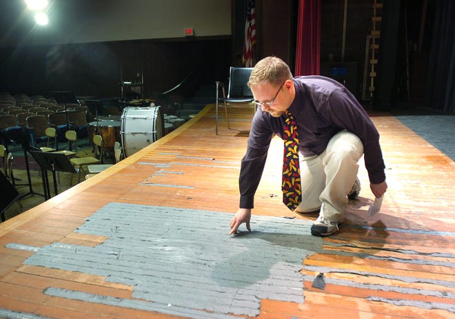 The stage in the auditorium at Rockland High School is falling apart. It's splintering and held together with duct tape in some areas. The latest problem is a termite infestation that results in bugs swarming around about two weeks every year. Matt Harden, Rockland Schools music director, shows the worst areas.