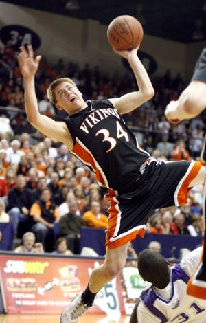 Hoover's Cory Veldhuizen is fouled by Barberton's Garrick Sims as he goes to the basket during the fourth quarter.
