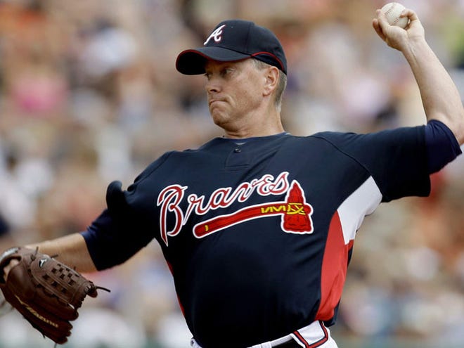 Atlanta Braves pitcher Tom Glavine throws to a New York Mets batter Saturday during the fist inning of a spring training baseball game in Kissimmee, Fla.