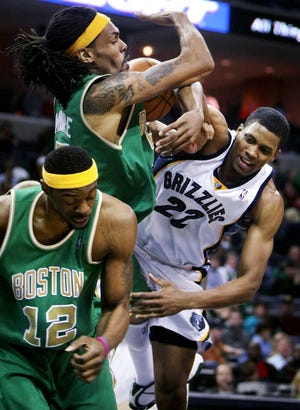 Memphis Grizzlies forward Rudy Gay (22) runs into a brick wall as he's fouled by Boston Celtics forward Mikki Moore, left, in the second half of the Celtics 105-87 win over the Grizzlies Saturday night.