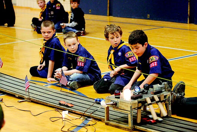 Participants intently watch a race during last week's Pinewood Derby.