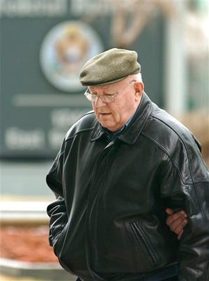 In this Feb. 28, 2005 file photo, John Demjanjuk arrives at the federal building in Cleveland for an immigration hearing. The U.S. government said Tuesday March 24, 2009 that it has contacted the German government to get travel documents needed to complete the deportation of accused Nazi guard Demjanjuk. The 88-year-old suburban Cleveland man is charged in Germany with 29,000 counts of acting as an accessory to murder while working as a guard at a Nazi death camp in occupied Poland during World War II.