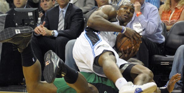 Orlando's Dwight Howard lands on top of Boston's Kendrick Perkins after grabbing a loose ball in the first half of Wednesday night's game, an 84-82 Magic victory.