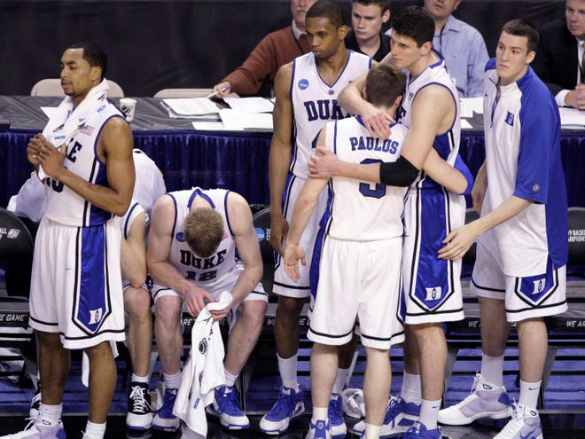 Duke players, from left, Gerald Henderson, Kyle Singler (12), Lance Thomas, Greg Paulus (3) and Brian Zoubek (55) console each other on the bench late in Thursday's 77-54 loss to Villanova in Boston.