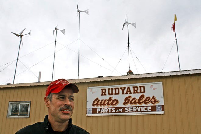 Mark Howland of Rudyard Auto Sales has seen a substantial savings in his electric bill following the installation of rooftop wind turbines. Howland has also put up a half dozen solar panels on his building — utilizing both the sun and wind to produce over 90 percent of the shop’s electrical needs.