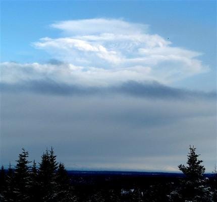 This photo released by the U.S. Geological Survey/Alaska Volcano Observatory, shows an eruption plume from the early morning eruption of Redoubt volcano rising above the horizon in Homer, Alaska Thursday, March 26, 2009. The eruption Thursday morning sent an ash cloud 65,000 feet above sea level the Alaska Volcano Observatory reported.