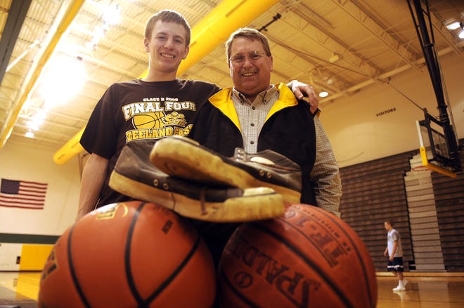 Zeeland East High School basketball player Andrew Meeuwsen, left, and his father, Dave, both fondly remember Andrew’s grandfather, Donald, a former player for the Chix. The family still has the basketball shoes, foreground, worn by Donald in the
1940s. Zeeland East will play tonight in the Class B semifinals in East Lansing.