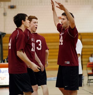 Millis' Alex Ortega (right) gives congratulations to teammates Sam Topazio (far left) and Charlie O'Keefe during the Mohawks' sweep of Marlborough yesterday.