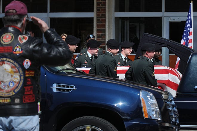 Spec. Norman Cain III's casket is placed in the hearse after a funeral service at Freeport High School Friday, March 27, 2009. Cain, a resident of Mt. Morris and graduate of Freeport High School died while serving in the National Guard iin Afghanistan on March 15, 2009.