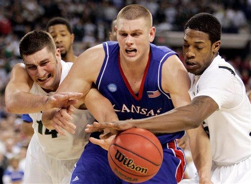 Cole Aldrich (center) found himself wishing he had better support as he battled a crowd of Michigan State players for a loose ball.