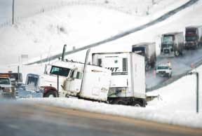CHIEFTAIN PHOTO/MIKE SWEENEY — A jackknifed semitrailer rests Friday in the snow-laden median of Interstate 25 south of Colorado City. The 59-year-old driver of the rig pulled over during white out conditions and later died from an undisclosed medical condition.