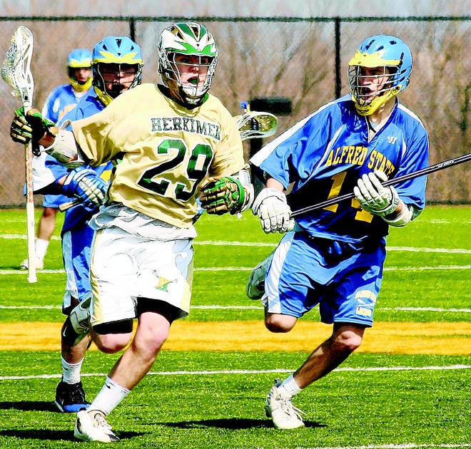 Zeppy O'Geen (29) leads the charge up the field after winning a faceoff in the second half for Herkimer County Community College Saturday.