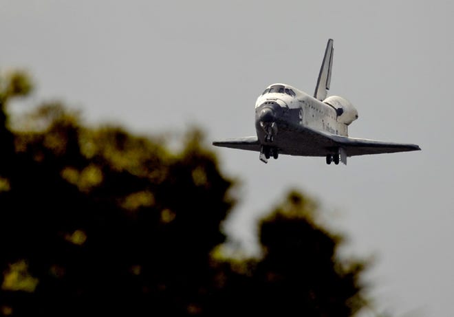 The space shuttle Discovery drops its landing gear before landing on runway 15 Saturday at the Kennedy Space Center in Cape Canaveral, Fla.