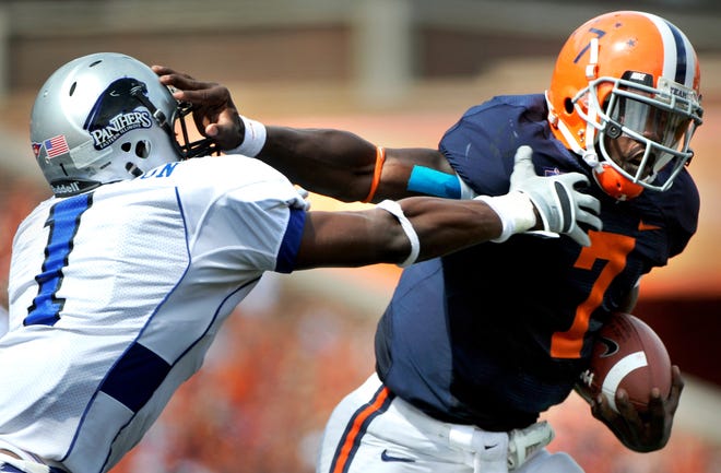 In this file photo, Illini quarterback Juice Williams pushes past Eastern's Adrian Arrington during the third quarter of their 47-21 win in 2008 over Eastern Illinois at Memorial Stadium in Champaign.